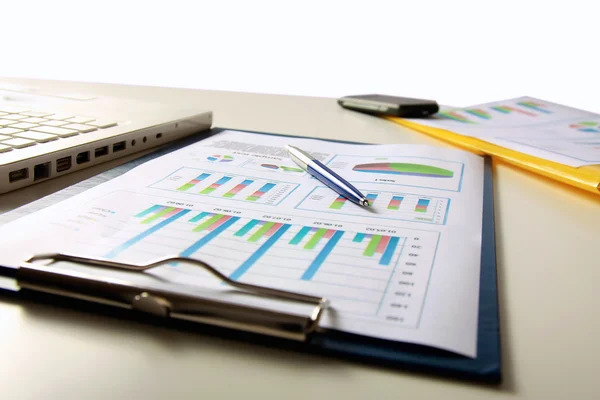 Businesswoman doing some paperwork at her desk using a calculator — Stock Photo, Image