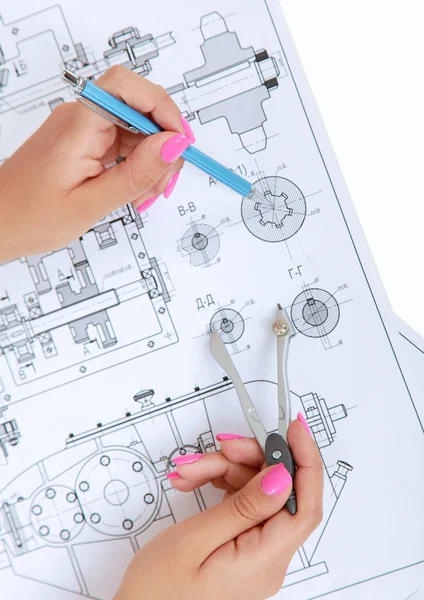 Female architect working with blueprints at office desk — Stock Photo, Image