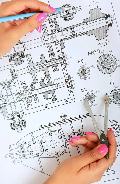 Female architect working with blueprints at office desk — Stock Photo, Image