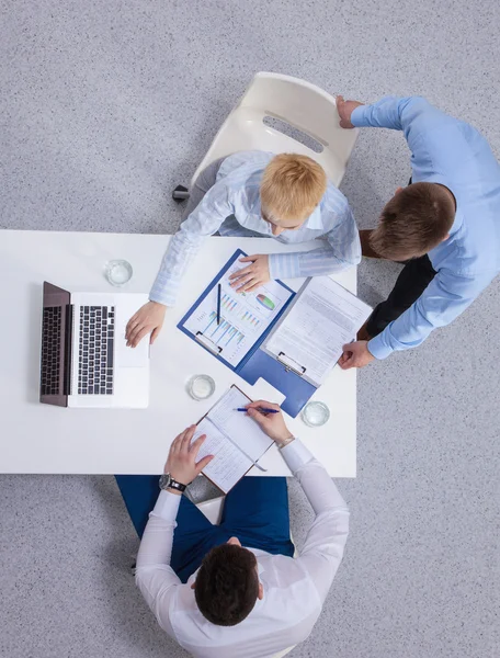 Business people sitting and discussing at business meeting, in office — Stock Photo, Image