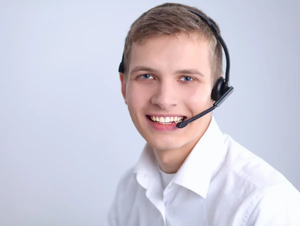 Müşteri Destek işleci ile bir kulaklık beyaz arka plan üzerinde — Stok fotoğraf