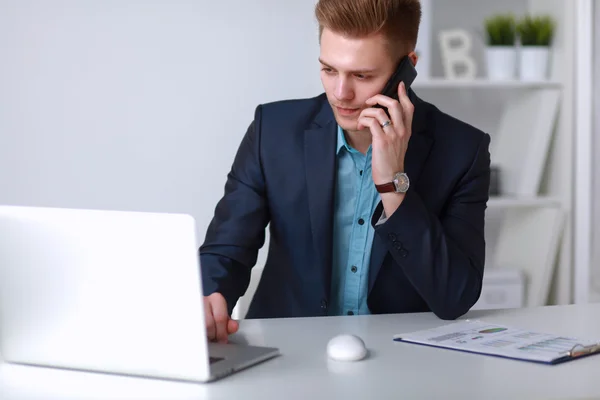 Young businessman working in office, sitting near desk — Stock Photo, Image