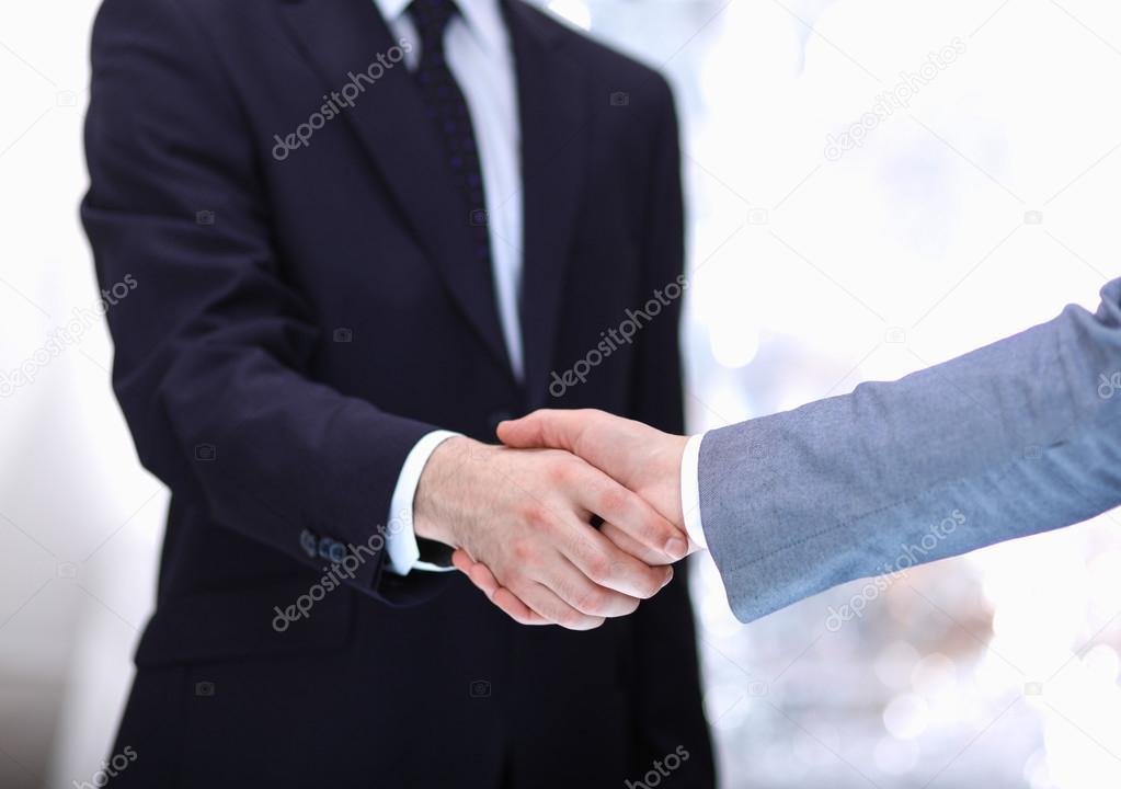 Businessmen shaking hands, isolated on white background