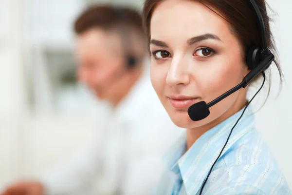 Businesswoman with headset smiling at camera in call center Stock Picture