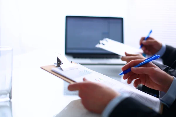 Businesspeople sitting on the desk on office — Stock Photo, Image