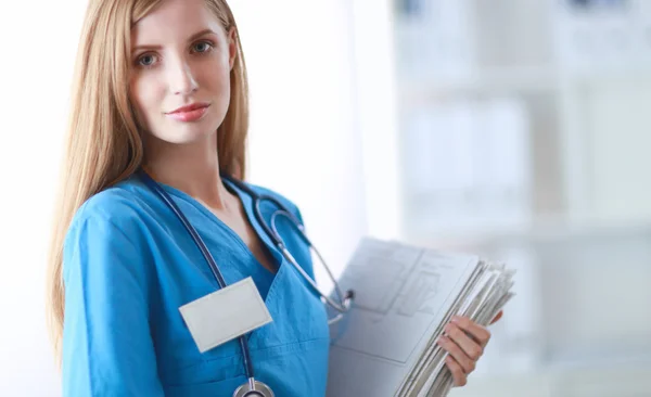 Portrait of woman doctor with folder at hospital corridor — Stock Photo, Image