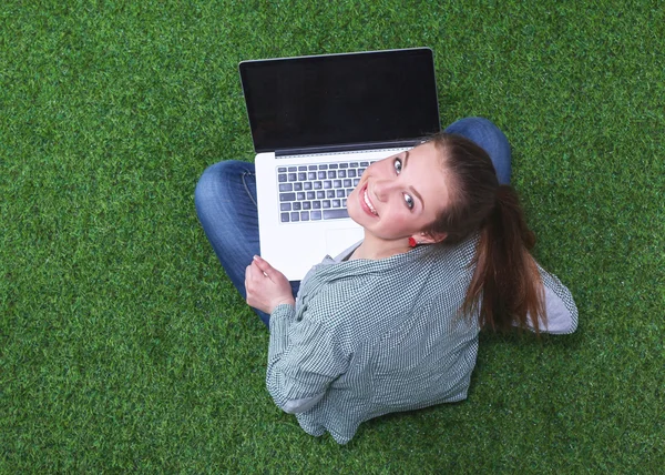 Young woman on the grass in park or garden with laptop — Stock Photo, Image