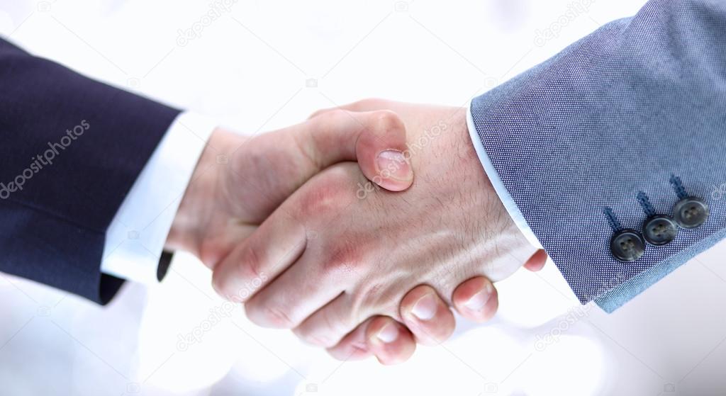 Businessmen shaking hands, isolated on white background