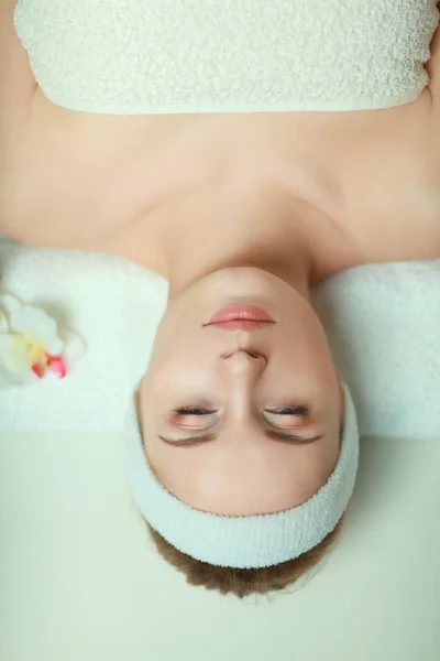 Beautiful young woman getting spa massage, lying on salon — Stock Photo, Image