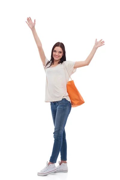 Smiling girl with headphones sitting on the floor near wall — Stock Photo, Image