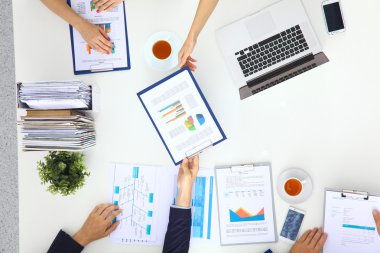 İş adamları iş toplantısında, ofiste oturup tartışıyorlar.