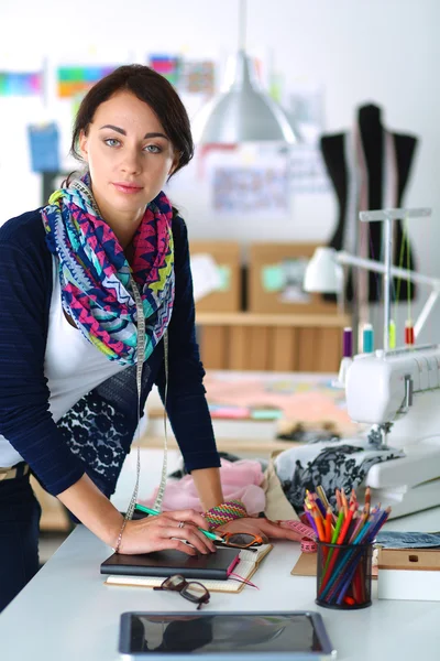 Dressmaker designing clothes pattern on paper — Stock Photo, Image