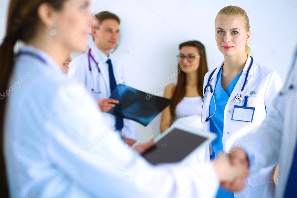 Young medical people handshaking at office