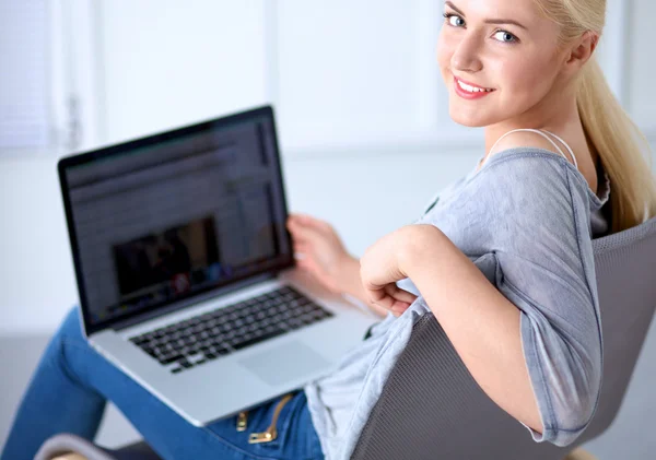 Jovem mulher bonita usando um computador portátil em casa — Fotografia de Stock