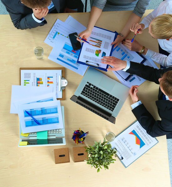 Business people sitting and discussing at business meeting, in office