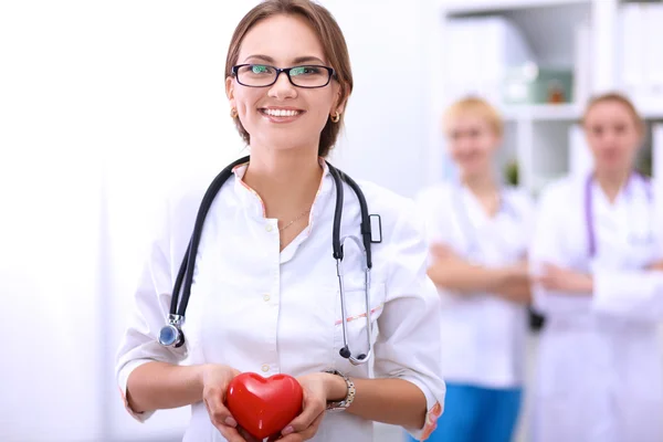 Doctor with stethoscope holding heart, isolated on white  background — Stock Photo, Image