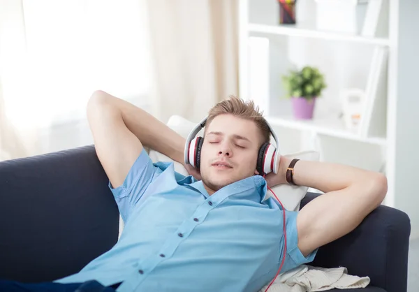 Man listening music with headphones at home — Stock Photo, Image