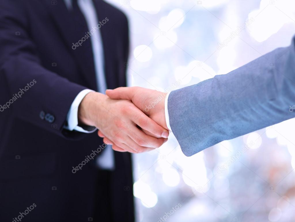 Businessmen shaking hands, isolated on white.