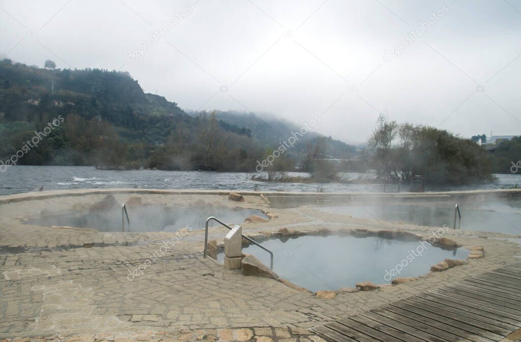 Hot springs Muino da Veiga, pools in Minho riverbed in Ourense, Spain