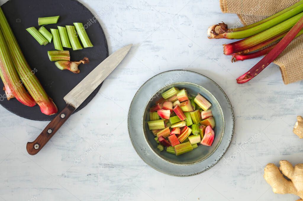 Chopped rhubarb stalks on the kitchen table, top view