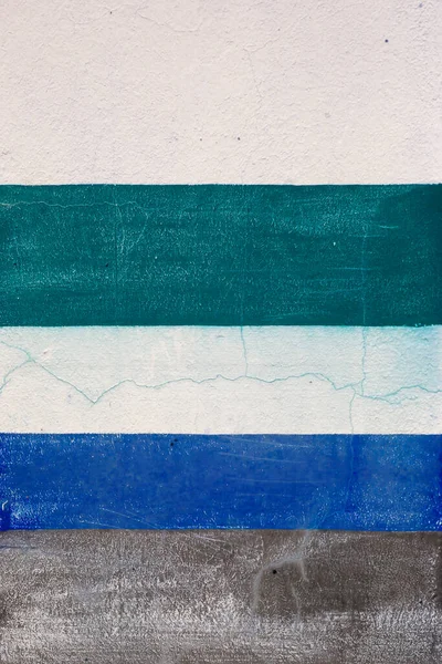 Blue and green teal stripes painted on white wall, abstract background or texture