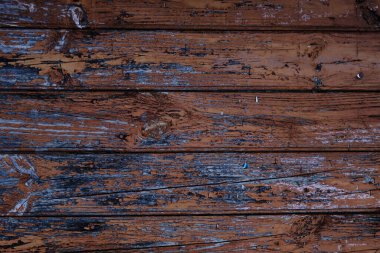 Old rustic wooden planks wall with brown peeling paint, grunge background or texture