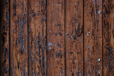 Old rustic wooden planks wall with brown peeling paint, grunge background or texture