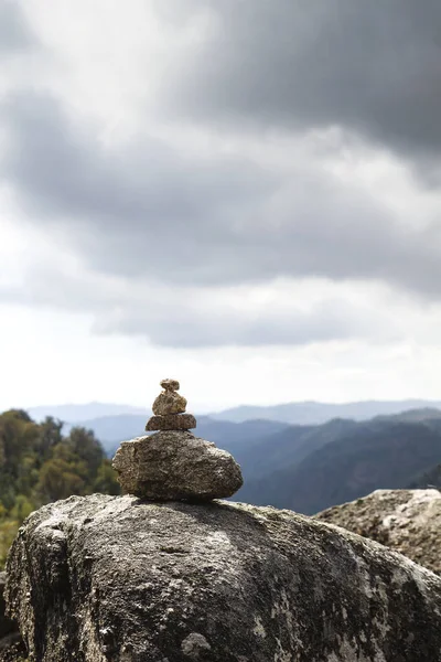 Cairn or stone marker in mountain trail