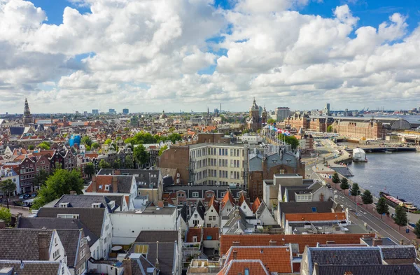 Beautiful View over Amsterdam Rooftops and Cityscape from Aerial perspective next to Oosterdok with Blue Sky and big clouds — Stock Photo, Image