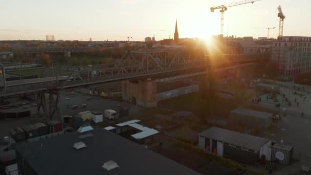 Oprichting van Shot of Iconic Berlin Yellow Subway Train passeren brug in prachtige buurt met zonsondergang, Luchtfoto Wide Drone Shot — Stockvideo