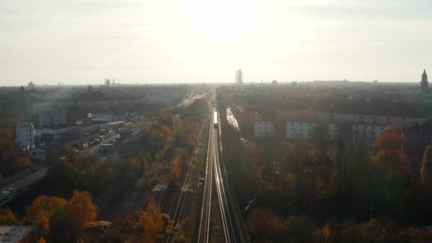 Elevated View above Train Tracks going through City with a Train in the distance, Aerial Wide View — Stock Video