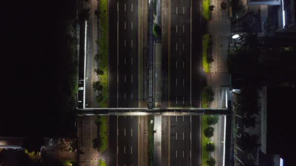 Vista aérea de arriba hacia abajo de la autopista vacía de varios carriles por la noche durante el bloqueo del coronavirus en el centro de la ciudad moderna — Vídeo de stock