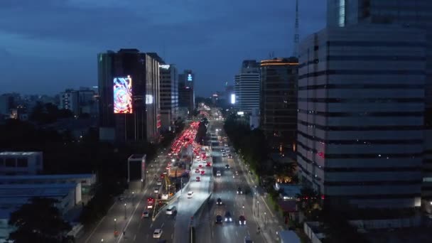 Alçaktan uçan arabaların görüntüsü kırmızı ışıktaki çok şeritli bir otoyolda trafiğin sonunda duruyor. — Stok video