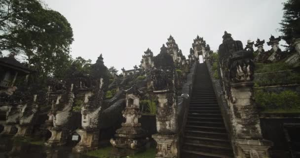 Primer plano de ángulo bajo camión de impresionantes esculturas de piedra cabeza de dragón en el templo Pura Penataran Agung Lempuyang en Bali Antiguas esculturas de piedra y escaleras en el templo hindú — Vídeos de Stock
