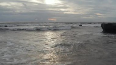 Akşam ışığında okyanusun kabarmasını yakından izle. Denizde bulutlu bir günde dalgalı deniz dalgaları