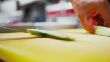 Yenmeyen yeşil salatalık merkezini çıkarıyorum. Mutfaktaki yeşil sebzeleri hazırlama manzarasını kapat.