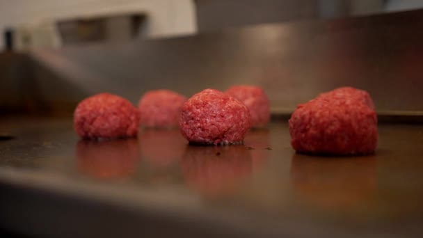 Fast food εργαζόμενος ισοπέδωση μπάλες κρέατος σε ένα ζεστό πιάτο στην κουζίνα εστιατόριο. Close up άποψη της επαγγελματικής παρασκευής κρέατος burger στο εστιατόριο fast food — Αρχείο Βίντεο