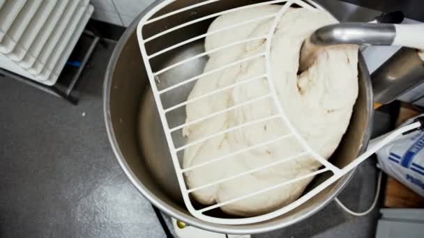 Overhead view of raw dough being mixed by a machine. Top down view of industrial dough mixing machine in a restaurant — Video Stock