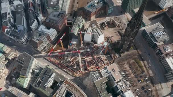 Aerial orbit of cranes and construction equipment by old St. Nikolai Memorial church in Hamburg city center — Stock Video