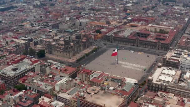 Erhöhter Blick auf die Catedral Metropolitana de la Ciudad de Mexico und die Plaza de la Constitucion mit riesiger Staatsflagge. Drohnenaufnahmen des historischen Stadtzentrums. Mexiko-Stadt. — Stockvideo