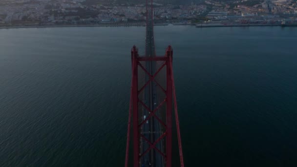 Aerial view of the traffic across Ponte 25 de Abril red bridge in evening light in Lisbon, Portugal — Stock Video