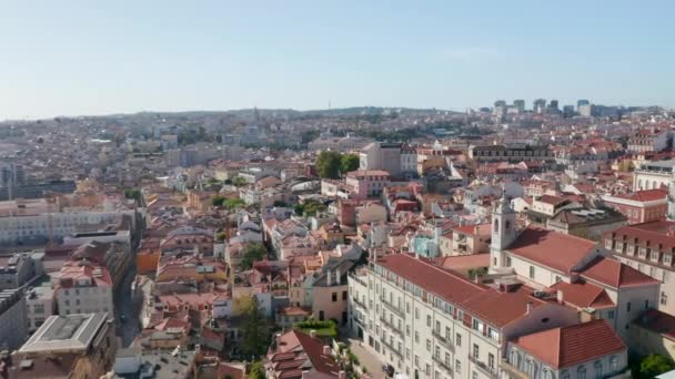 Panning aerial view of town in sunny day. Rooftop view from flying drone. Lisbon, capital of Portugal. — Stock Video