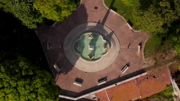 Aves aéreas olho em cima vista para baixo da praça da cidade com parque. Vários bancos em volta da fonte em frente ao Palácio Necessidades. A ver as imagens do drone. Lisboa, capital de Portugal. — Vídeo de Stock