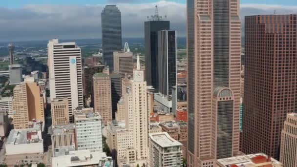 Aerial panning view tall modern office buildings downtown. Drone moving around Mercantile National Bank Building with tower and big clock. Dallas, Texas, US — Stock Video