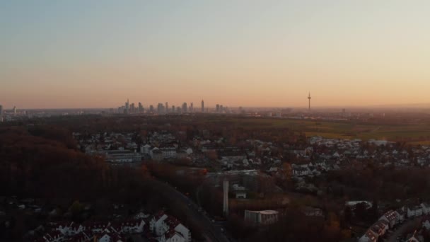 Aerial evening view on Frankfurt am Main city panorama from distance. Drone flying above small town neighbourhood. Bad Vilbel, Germany. — Stock Video