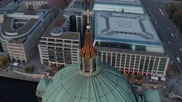 Beelden van het koepeldak van de kathedraal van Berlijn met religieus kruis. Commerciële gebouwen, DDR museum en verkeer in de omliggende straat op de achtergrond. Berlijn, Duitsland. — Stockvideo