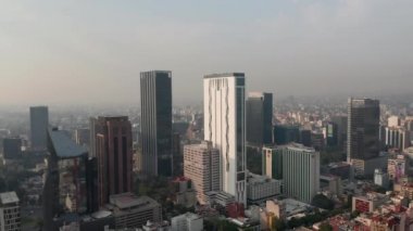 Şehir merkezindeki Panorama Virajı. Yüksek ofis binalarına doğru uçuyor. Hava kirliliği nedeniyle görüş mesafesi sınırlı. Mexico City, Meksika.