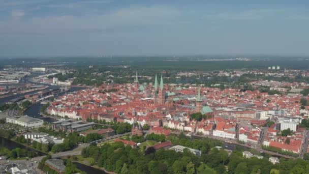 Aerial panoramic view of medieval city centre. Fly around historic brick buildings, churches with tall towers. Luebeck, Schleswig-Holstein, Germany — Stock Video