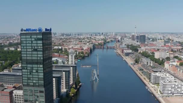 Aerial view of Spree river at Treptower building complex and Molecule Man sculpture on water. Cityscape with Fernsehturm in background. Berlin, Germany — Stock Video