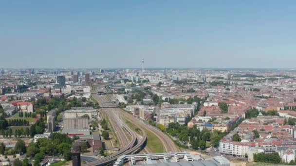 Transport infrastructure in town. Aerial view on cityscape with railway track. Fernsehturm TV tower in distance. Berlin, Germany — Stock Video